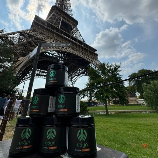 A pyramid of Edyn Elixir Ignite jars under the Eiffel Tower